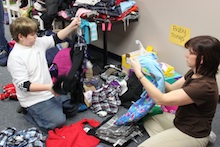 Volunteers sort items donated to Northeast Parent & Child Society's Holiday Hope Fund